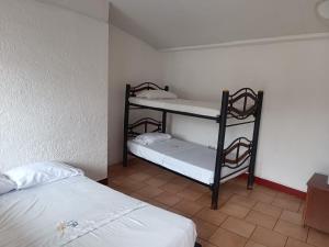 a room with two bunk beds in a room at Hotel Santo Lomo in La Vega