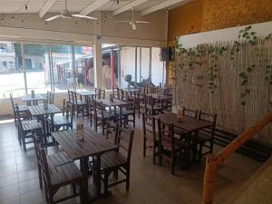 a restaurant with wooden tables and chairs in a room at Hotel Santo Lomo in La Vega