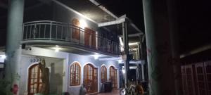 a building with a balcony on top of it at Fern Forest Eco Village in Ocho Rios