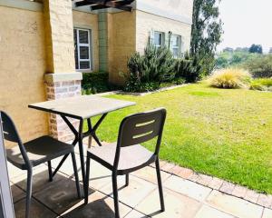 a table and two chairs sitting on a patio at Pont de Val Studio Apartment in Parys