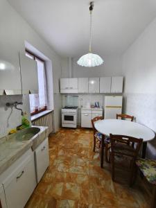 a kitchen with a table and a dining room at Regina Margherita Apartment in Rocchetta Ligure
