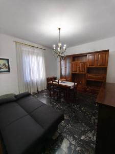 a living room with a couch and a dining room at Regina Margherita Apartment in Rocchetta Ligure