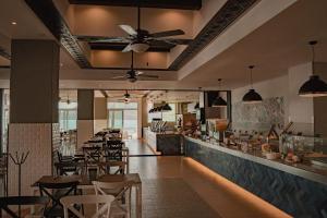 a restaurant with a bunch of tables and chairs at Oceano Palace in Mazatlán