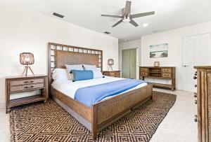 a bedroom with a large bed and two night stands at Htd Saltwater Pool! Walk To Beach! Pingpong! Bbq! in West Palm Beach +64 photos
