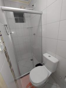 a white bathroom with a shower and a toilet at Kayc pousada in Amargosa +10 photos
