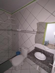 a bathroom with a toilet and a sink at Kayc pousada in Amargosa