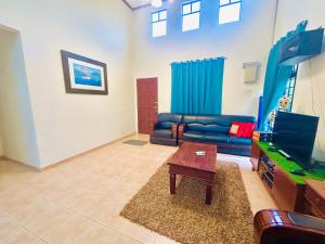 a living room with a couch and a table at The 5R Famosa Villa in Kampong Ulu Pegoh