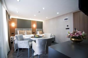 a room with a bed and a table and chairs at Grand Bagoz Hotel in Istanbul