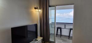 a room with a flat screen tv and a balcony at B661 SilverparkResort -walk up in Bukit Fraser