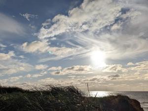 een bewolkte lucht boven de oceaan en een strand bij 6 person holiday home in Ringkøbing in Ringkøbing
