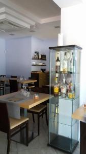 Hotel Main Street في تْشيراسولو: خزانة زجاجية مع زجاجات في مطعم
