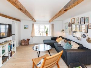 a living room with a couch and a table at 5 person holiday home in Løkken in Løkken