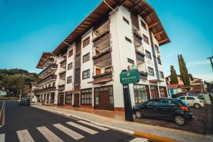 a car parked in front of a building on a street at Hotel Alpenrose in Treze Tílias