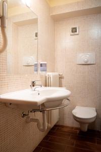 a bathroom with a sink and a toilet at Hotel La Coccinella in Lavello +21 photos