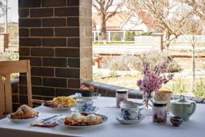 a table with plates of food on top of it at Barbour House in Gunning