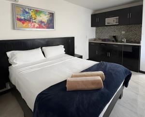 a bedroom with a large bed with a towel on it at Casa Balam Gladiolas in Cancún