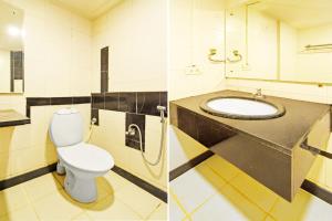 a bathroom with a toilet and a sink at Super Townhouse Ameerpet Balkampet Road in Hyderabad +24 photos