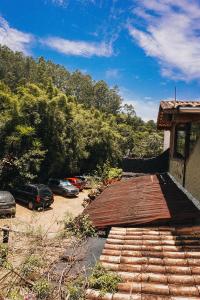 a house with cars parked in a parking lot at Espaço Casa Mato in Taubaté
