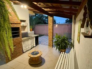 a patio with a table and a fireplace at Casa Bela Vista - Penedo in Penedo