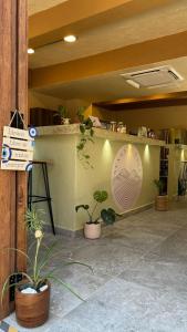 a restaurant with a sign on a wall with plants at Hotel Boutique Lomas Colonial in Santa Fe de Antioquia +84 photos