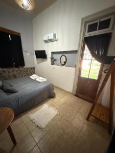 a bedroom with a bed and a window and a door at Sayani Posada in Chilecito