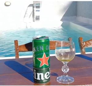 a can of beer sitting next to a glass of wine at Casa com piscina! Descanso e Lazer in Itapoa