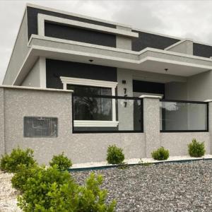 a modern house with a lot of windows at Casa com piscina! Descanso e Lazer in Itapoa