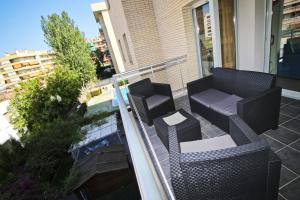 een balkon met 2 stoelen en een bank bij Roura 2 Planetcostadorada in La Pineda