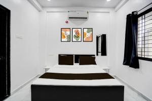 a bedroom with two beds in a white room at Hotel O neom inn in Rāipur
