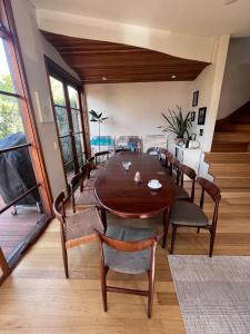 a dining room with a wooden table and chairs at Nelson - architect designed oasis Port Melbourne in Melbourne