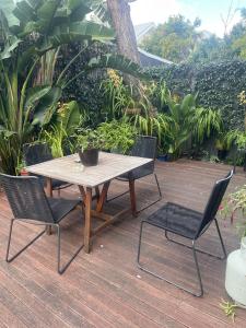 a wooden table and two chairs on a wooden deck at Nelson - architect designed oasis Port Melbourne in Melbourne +12 photos