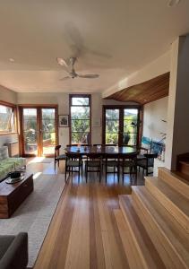 a living room with a table and chairs at Nelson - architect designed oasis Port Melbourne in Melbourne