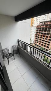 a balcony with two benches and a window with a building at Studio 604 - Seu refúgio Urbano no Coração de São Paulo - Wifi, Vaga, Academia, Lavanderia, Mercado e Rooftop in Sao Paulo
