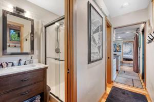 a bathroom with a sink and a mirror at Two Pines - Unique container home w/hot tub - Downtown - Trailer Parking - Pet friendly in McCall +33 photos