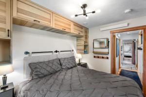 a bedroom with a bed in a rv at Two Pines - Unique container home w/hot tub - Downtown - Trailer Parking - Pet friendly in McCall