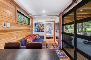 a living room with a couch and a table at Two Pines - Unique container home w/hot tub - Downtown - Trailer Parking - Pet friendly in McCall