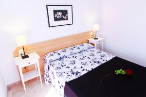 a small bedroom with a bed and two night stands at Ventura 3 Planetcostadorada in Salou +22 photos