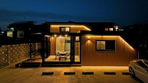 a small house with a patio at night at Byeolbitdam Yangyang in Yangyang