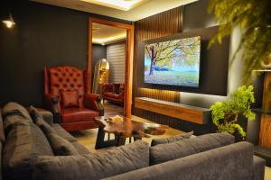 a living room with a couch and a tv at Goldcrest Mall & Residency - Luxury 1bhk, 2bhk, 3bhk Apartments in DHA Lahore in Lahore +261 photos