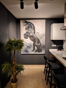 a painting of a horse on the wall in a kitchen at Goldcrest Mall & Residency - Luxury 1bhk, 2bhk, 3bhk Apartments in DHA Lahore in Lahore
