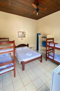 a bedroom with two bunk beds and a ceiling at Pousada do Marcão in Ubatuba