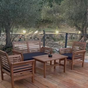 three wooden benches and a table on a wooden deck at BEV's Hideaway  +18 photos
