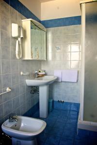 a bathroom with a sink and a toilet at Hotel La Bussola in Muggia