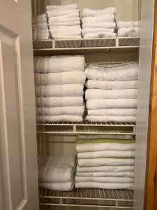 a closet filled with lots of white towels at Relaxing with Hot Tub - Pond Front & Outdoor Fire Place Upstate - Catskills in Athens