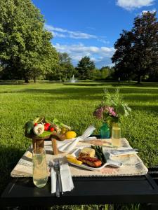 a picnic table with food on it in a park at Relaxing with Hot Tub - Pond Front & Outdoor Fire Place Upstate - Catskills in Athens