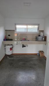 a kitchen with a counter and a sink in a room at Casa Quinta en Villa Nueva Córdoba in Villa Nueva