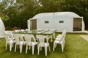a table and white chairs and a white tent at Casa Galileo in Barra de Navidad