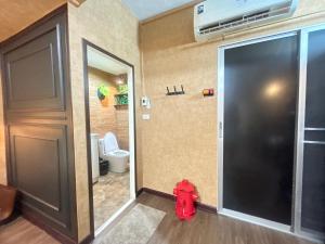 une salle de bain avec une bouche d'incendie devant une porte dans l'établissement Secret Retro Vintage Building ห้องลับเรโทรในตึกวินเทจ, à Ban Song Hong