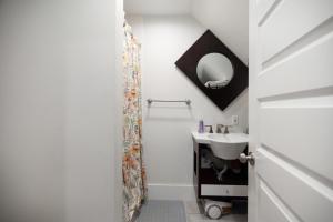 a bathroom with a sink and a mirror at Amazing Location studio parking in Boston +21 photos