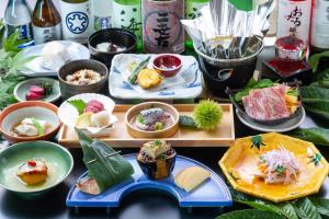 a table topped with different types of food in bowls at Niseko Hot Spring Ikoino Yuyado Iroha in Niseko